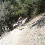 An action shot of Elizabeth hiking up the trail.