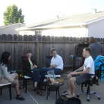 Anjali, Ashley, Ted, and Chris chatting, while Tanya does all of the hard work at the grill