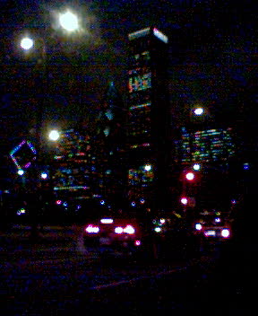 the city skyline at night (grainy)