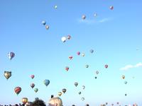 A shot of the sky, absolutely filled with hot-air balloons.